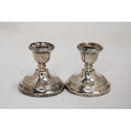 26 - A PAIR OF HALLMARKED BIRMINGHAM SILVER WEIGHTED CANDLESTICKS - 7.5 CM GROSS WEIGHT 238.69 G