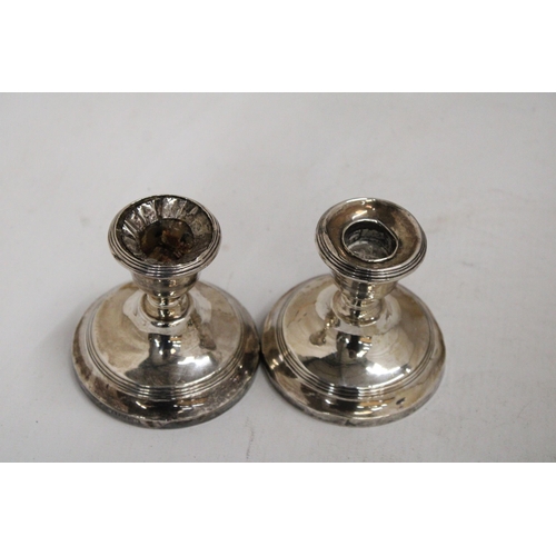 26 - A PAIR OF HALLMARKED BIRMINGHAM SILVER WEIGHTED CANDLESTICKS - 7.5 CM GROSS WEIGHT 238.69 G