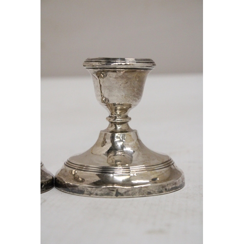 26 - A PAIR OF HALLMARKED BIRMINGHAM SILVER WEIGHTED CANDLESTICKS - 7.5 CM GROSS WEIGHT 238.69 G