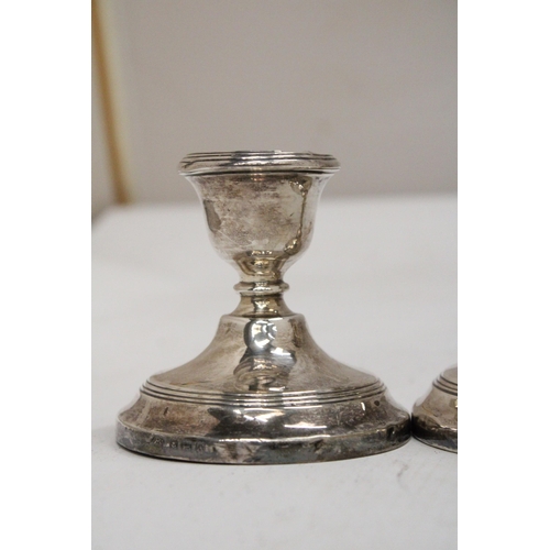 26 - A PAIR OF HALLMARKED BIRMINGHAM SILVER WEIGHTED CANDLESTICKS - 7.5 CM GROSS WEIGHT 238.69 G