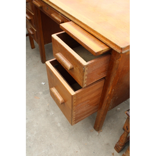 2817 - A MID 20TH CENTURY OAK TWIN PEDESTAL DESK ENCLOSING SIX DRAWERS AND TWO SLIDES, 53