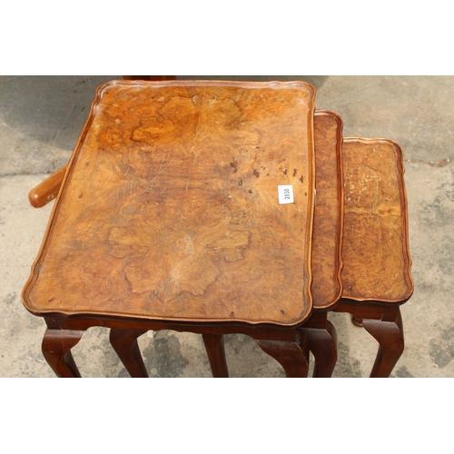 2838 - A NEST OF THREE WALNUT TABLES ON CABRIOLE LEGS