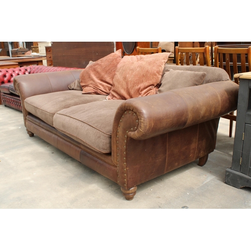 2865 - A LEATHER THREE SEATER SETTEE AND FOUR CUSHIONS