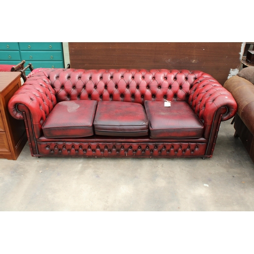 2866 - AN OXBLOOD CHESTERFIELD THREE SEATER SETTEE