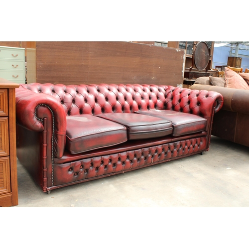 2866 - AN OXBLOOD CHESTERFIELD THREE SEATER SETTEE