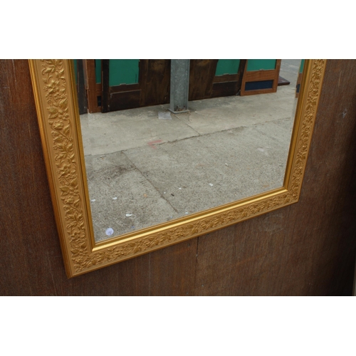 2874 - A GILT EFFECT BEVEL EDGE WALL MIRROR WITH FOLIATE DECORATION, 42