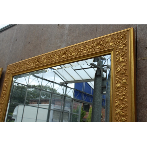 2881 - A GILT EFFECT BEVEL EDGE WALL MIRROR WITH FOLIATE DECORATION, 29