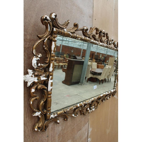 2884 - A ROCOCO STYLE GILT FRAMED WALL MIRROR, 46