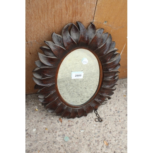 2885 - AN OVAL OAK WALL MIRROR WITH BEVEL EDGE AND LEAF CARVINGS TO EDGE, 16