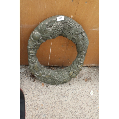 2888 - A RESIN WALL MIRROR FRAME DECORATED WITH LEAVES AND FRUIT, 23