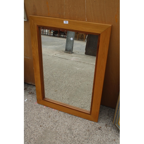 2890 - A MORRIS FURNITURE OAK FRAMED WALL MIRROR, 37