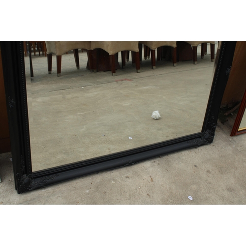 2895 - AN ARQADIA BLACK FRAMED WALL MIRROR, 46