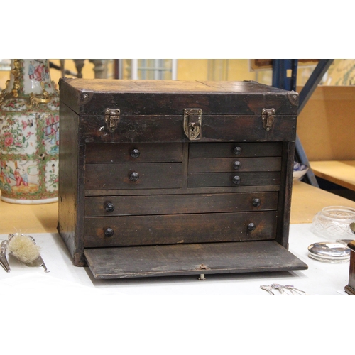 52 - A VINTAGE OAK ENGINEER'S BOX WITH SEVEN DRAWERS, LIFT UP LID AND PULL OUT CUPBOARD FRONT WITH METAL ... 