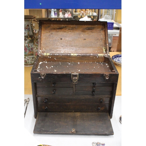 52 - A VINTAGE OAK ENGINEER'S BOX WITH SEVEN DRAWERS, LIFT UP LID AND PULL OUT CUPBOARD FRONT WITH METAL ... 