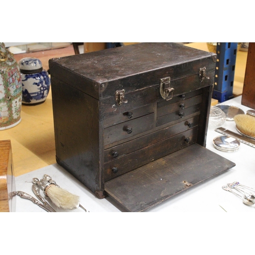 52 - A VINTAGE OAK ENGINEER'S BOX WITH SEVEN DRAWERS, LIFT UP LID AND PULL OUT CUPBOARD FRONT WITH METAL ... 