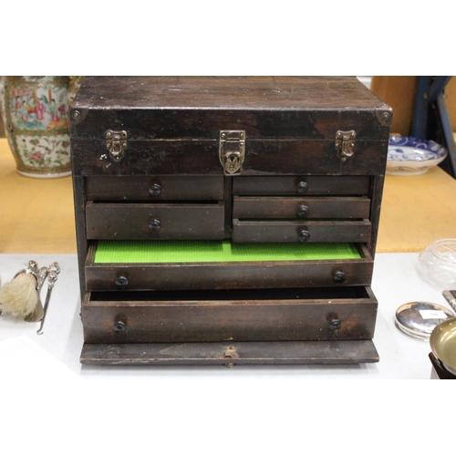 52 - A VINTAGE OAK ENGINEER'S BOX WITH SEVEN DRAWERS, LIFT UP LID AND PULL OUT CUPBOARD FRONT WITH METAL ... 