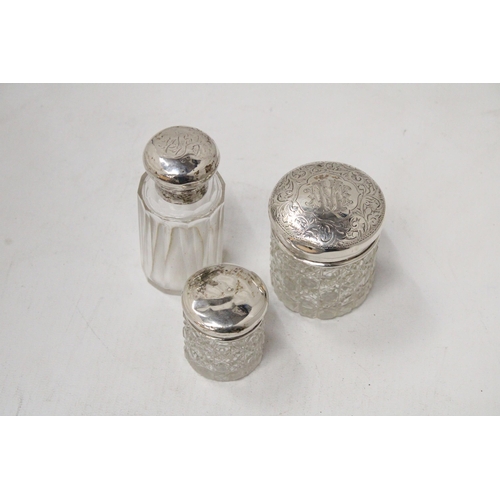 59 - THREE HALLMARKED CHESTER, BIRMINGHAM AND LONDON SILVER LIDDED ITEMS TO INCLUDE A SCENT BOTTLE AND TW... 