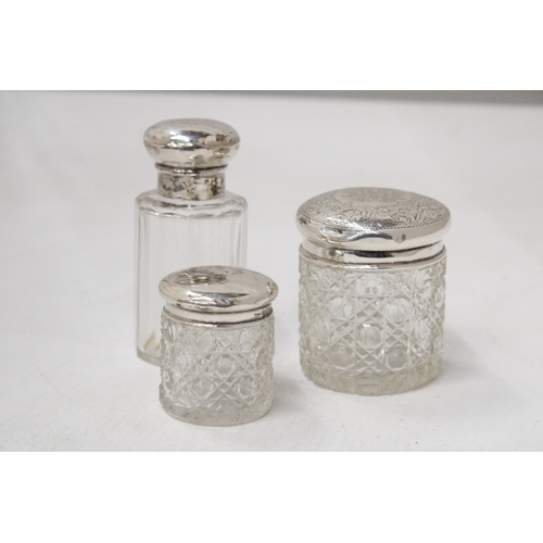 59 - THREE HALLMARKED CHESTER, BIRMINGHAM AND LONDON SILVER LIDDED ITEMS TO INCLUDE A SCENT BOTTLE AND TW... 