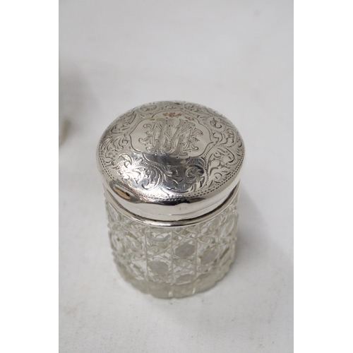 59 - THREE HALLMARKED CHESTER, BIRMINGHAM AND LONDON SILVER LIDDED ITEMS TO INCLUDE A SCENT BOTTLE AND TW... 