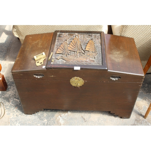 2950 - A CAMPHOR WOOD ORIENTAL BLANKET CHEST WITH CARVED PANEL TOP DEPICTING A JUNK, 36