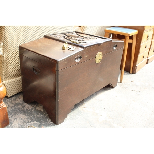 2950 - A CAMPHOR WOOD ORIENTAL BLANKET CHEST WITH CARVED PANEL TOP DEPICTING A JUNK, 36