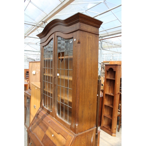 2976 - AN EARLY 20TH CENTURY OAK BUREAU BOOKCASE WITH GLAZED AND LEADED UPPER PORTION, 37