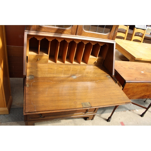 2976 - AN EARLY 20TH CENTURY OAK BUREAU BOOKCASE WITH GLAZED AND LEADED UPPER PORTION, 37