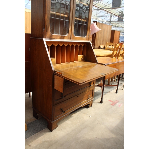 2976 - AN EARLY 20TH CENTURY OAK BUREAU BOOKCASE WITH GLAZED AND LEADED UPPER PORTION, 37