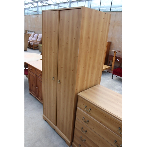 2989 - A MODERN PINE EFFECT BEDROOM SUITE COMPRISING TWO WARDROBES, CHEST OF FIVE DRAWERS AND A PAIR OF BED... 