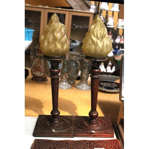 60 - A PAIR OF WOOD AND COPPER LAMP BASES WITH FLAME SHADES