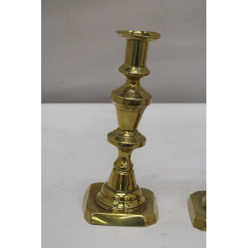 245 - A PAIR OF VINTAGE BRASS CANDLESTICKS, HEIGHT 26CM