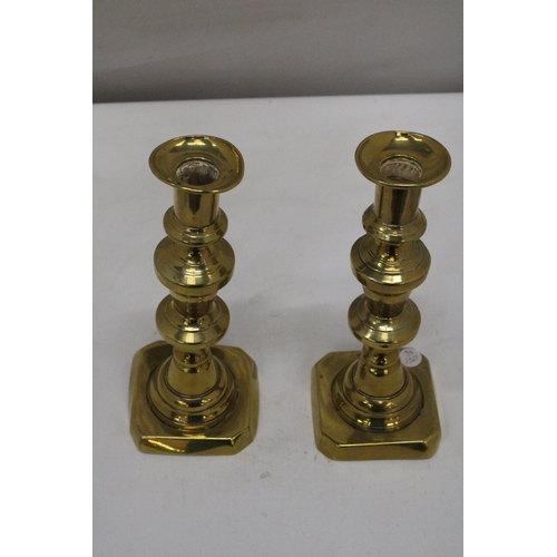 245 - A PAIR OF VINTAGE BRASS CANDLESTICKS, HEIGHT 26CM