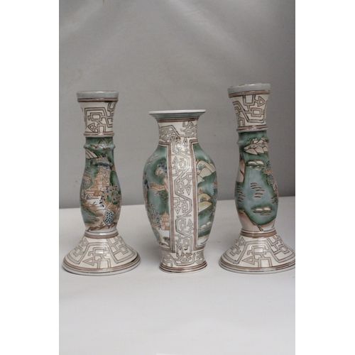 335 - A VINTAGE CHINESE ENAMELLED PORCELAIN VASE TOGETHER WITH A PAIR OF MATCHING CANDLESTICKS BOTH WITH R... 