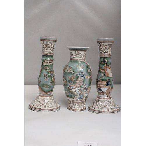 335 - A VINTAGE CHINESE ENAMELLED PORCELAIN VASE TOGETHER WITH A PAIR OF MATCHING CANDLESTICKS BOTH WITH R... 