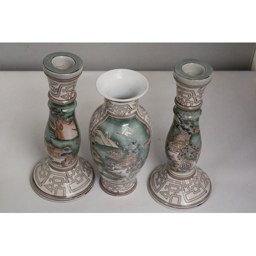 335 - A VINTAGE CHINESE ENAMELLED PORCELAIN VASE TOGETHER WITH A PAIR OF MATCHING CANDLESTICKS BOTH WITH R... 