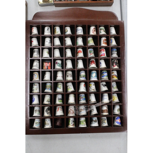 142 - A LARGE QUANTITY OF THIMBLES IN DISPLAY CASES PLUS GLASS 