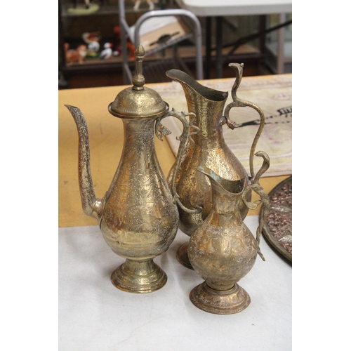 38 - TWO BRASS ETCHED EWERS WITH SERPENT HANDLE TOGETHER WITH A MIDDLE EASTERN BRASS DALLAH COFFEEPOT