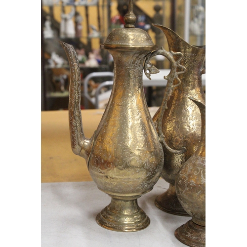 38 - TWO BRASS ETCHED EWERS WITH SERPENT HANDLE TOGETHER WITH A MIDDLE EASTERN BRASS DALLAH COFFEEPOT