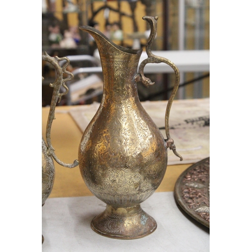 38 - TWO BRASS ETCHED EWERS WITH SERPENT HANDLE TOGETHER WITH A MIDDLE EASTERN BRASS DALLAH COFFEEPOT