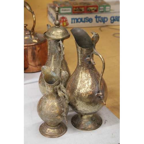 38 - TWO BRASS ETCHED EWERS WITH SERPENT HANDLE TOGETHER WITH A MIDDLE EASTERN BRASS DALLAH COFFEEPOT