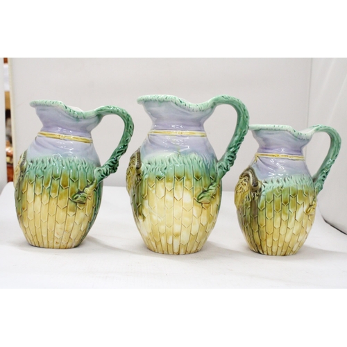 6 - THREE 19TH CENTURY ADAMS & BROMLEY ENGLISH MAJOLICA RAM HEAD GRADUATED JUGS