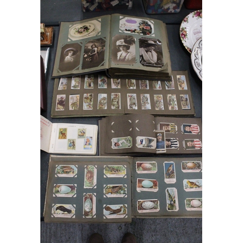 158 - A QUANTITY OF VINTAGE CIGARETTE CARDS IN ALBUMS TO INCLUDE OGDENS AND WILLS TOGETHER WITH A FURTHER ... 