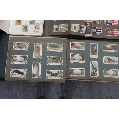 158 - A QUANTITY OF VINTAGE CIGARETTE CARDS IN ALBUMS TO INCLUDE OGDENS AND WILLS TOGETHER WITH A FURTHER ... 