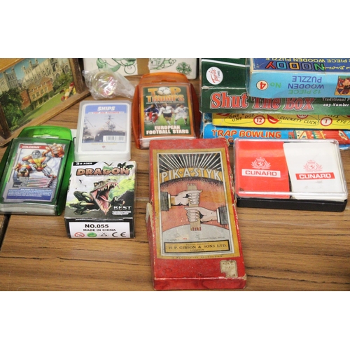 557 - A QUANTIY OF VINTAGE BOARD GAMES, TOP TRUMPS AND THEMED MONEY BOXES