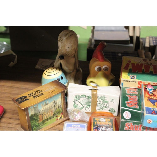 557 - A QUANTIY OF VINTAGE BOARD GAMES, TOP TRUMPS AND THEMED MONEY BOXES