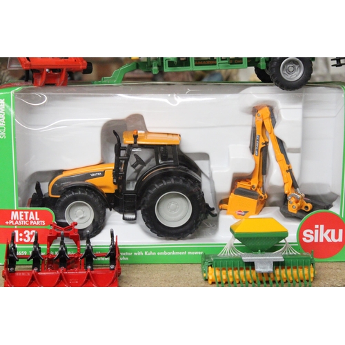 220 - FOUR SIKU 1:32 SCALE FARM MODELS TO INCLUDE A VALTRA TRACTOR WITH KUHN EMBANKMENT MOWER (AS NEW IN B... 