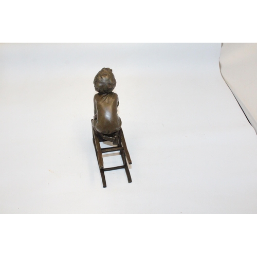 70 - A BRONZE FIGURE OF A CHILD ON A CHAIR - SIGNED