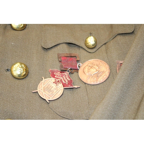 72 - A MEN'S MILITARY TUNIC WITH BRASS MEDALS