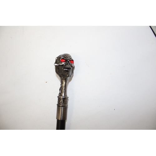 76 - A WALKING STICK WITH A METAL SKULL FINIAL