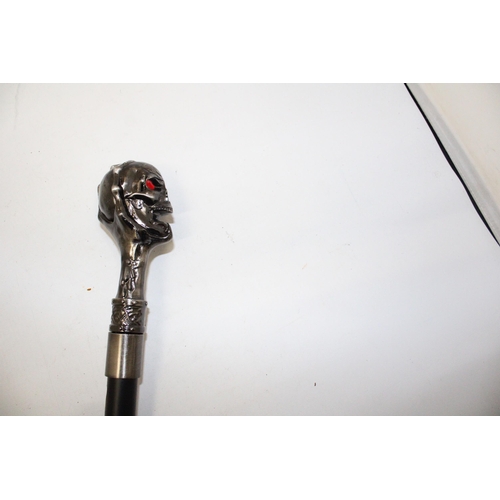 76 - A WALKING STICK WITH A METAL SKULL FINIAL